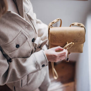 Unrecognizable fashionable woman holding a modern purse.