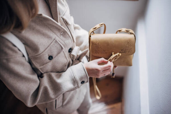 Unrecognizable fashionable woman holding a modern purse.