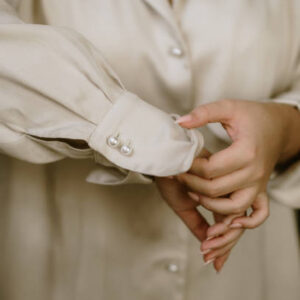 Close up of a woman adjusting her shirt sleeve